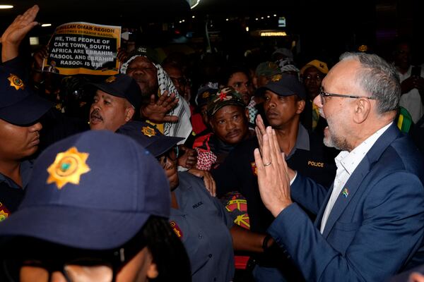 Expelled South Africa Ambassador Ebrahim Rasool speaks to supporters following his arrival, at Cape Town International Airport in Cape Town, South Africa, Sunday, March 23, 2025. (AP Photo/Nardus Engelbrecht)