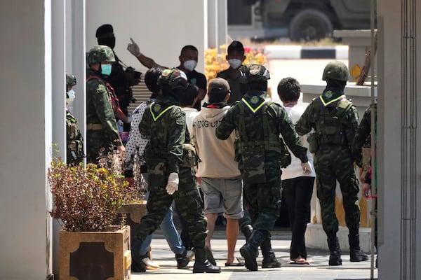 Thai soldiers provide security for Indonesian nationals being sent home after being forced to work at scam centers in eastern Myanmar in Mae Sot, Thailand on Thursday, Feb. 27, 2025. (AP Photo/Sakchai Lalit)