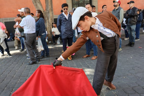 A young supporter of bullfighting joins a protest in support of bullfighting outside Mexico's City's Congress where lawmakers are expected to debate its continuation in Mexico City, Tuesday, March 18, 2025. (AP Photo/Ginnette Riquelme)