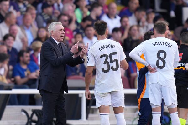 Real Madrid's head coach Carlo Ancelotti, left, gives instructions during the Spanish La Liga soccer match between Barcelona and Real Madrid at the Lluis Companys Olympic Stadium in Barcelona, Spain, Sunday, May 11, 2025. (AP Photo/Jose Breton)