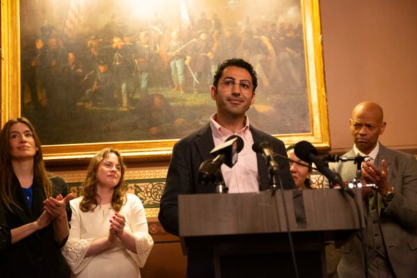 Mohsen Mahdawi, center, speaks during a press conference announcing the launch of the Vermont Immigration Legal Defense Fund in the Cedar Creek Reception Room at the Vermont State House on Thursday, May 8, 2025, in Montpelier, Vt. (AP Photo/Alex Driehaus)