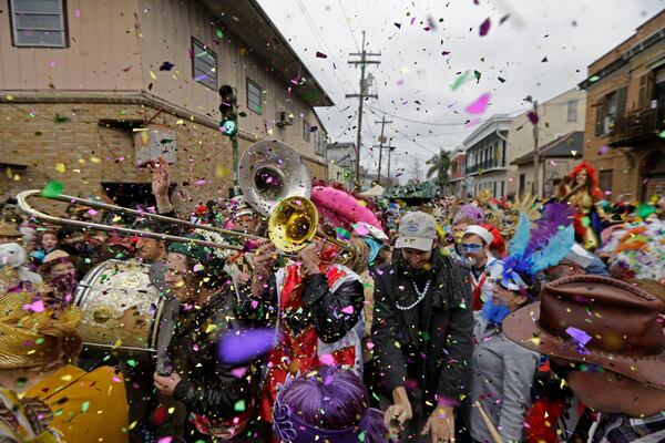 FILE - Revelers play brass band music as they begin the march of the Society of Saint Anne Mardi Gras parade in New Orleans, Feb. 17, 2015. (AP Photo/Gerald Herbert, File)