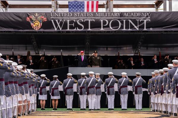President Donald Trump salutes alongside Lieutenant General Steven W. Gilland during the U.S. Military Academy commencement ceremonies in West Point, N.Y., Saturday, May 24, 2025. (AP Photo/Adam Gray)