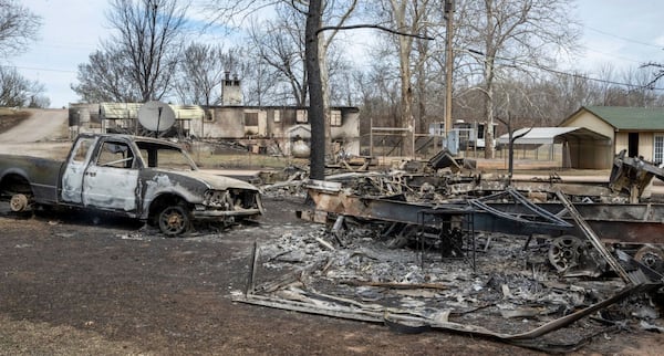 Several RVs and a truck burned from Friday's wildfires not far from a larger structure that burned at Pecan Valley RV Park shown Saturday, March 15, 2025, on the west edge of Stillwater, Okla. (Jason Elmquist/The News Press via AP)