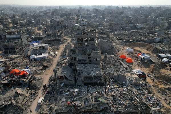 An aerial photograph taken by a drone shows tents amidst the destruction caused by the Israeli air and ground offensive in Beit Lahiya, northern Gaza Strip, on Monday, Feb. 17, 2025. (AP Photo/Mohammad Abu Samra)