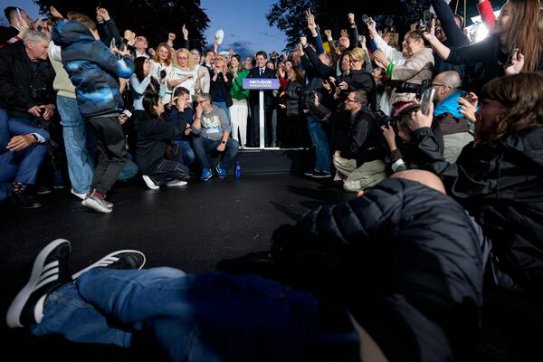 Presidential candidate Nicusor Dan, center, speaks to supporters after polls closed for the second round of the country's presidential election redo in Bucharest, Romania, Sunday, May 18, 2025. (AP Photo/Andreea Alexandru)