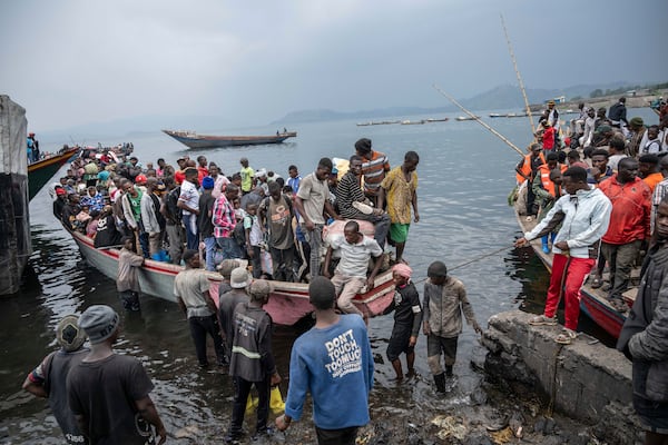 People fleeing M-23 rebel advances arrive by boat in Goma, Democratic Republic of the Congo, Wednesday, Jan. 22, 2025. (AP Photo/Moses Sawasawa)