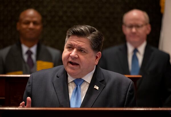 Illinois Gov. JB Pritzker delivers his annual budget address in front of House Speaker Emanuel "Chris" Welch, left, and Senate President Don Harmon, Wednesday, Feb. 19, 2025, at the Illinois State Capitol in Springfield. Ill. (Brian Cassella/Chicago Tribune via AP, Pool)