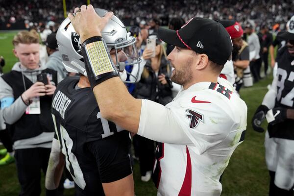 Atlanta Falcons quarterback Kirk Cousins (18) greets Las Vegas Raiders quarterback Desmond Ridder (10) after an NFL football game, Monday, Dec. 16, 2024, in Las Vegas. (AP Photo/Rick Scuteri)