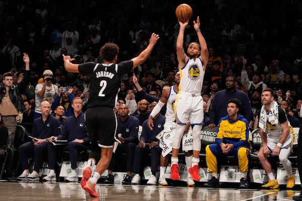 Golden State Warriors' Stephen Curry (30) shoots a three-point shot over Brooklyn Nets' Cameron Johnson (2) during the second half of an NBA basketball game Thursday, March 6, 2025, in New York. (AP Photo/Frank Franklin II)