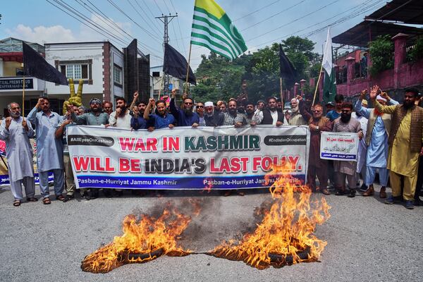 Supporters of Pasban-e-Hurriyat Jammu and Kashmir chant slogans next to burning tires during an anti-India demonstration, in Muzaffarabad, the capital of Pakistan administered Kashmir, Monday, May 5, 2025. (AP Photo/M.D. Mughal)