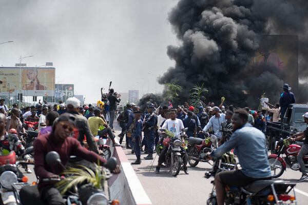 People protest in Kinshasa, Democratic Republic of the Congo Tuesday, Jan. 28, 2025, against the Rwanda-backed M23 rebels' advances into eastern Congos capital Goma.(AP Photo/Samy Ntumba Shambuyi)