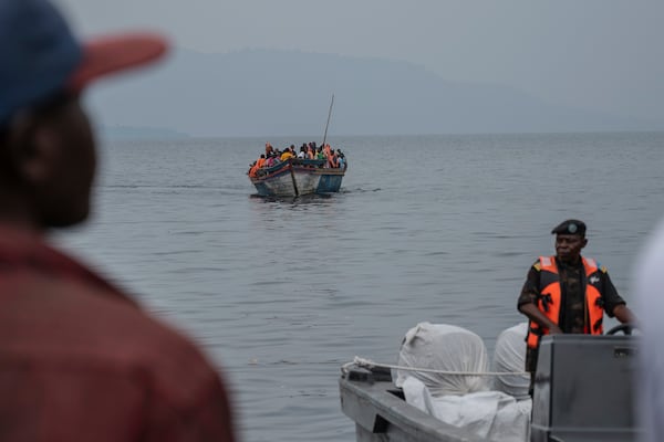 People fleeing M-23 rebel advances arrive by boat in Goma, Democratic Republic of the Congo, Wednesday, Jan. 22, 2025. (AP Photo/Moses Sawasawa)