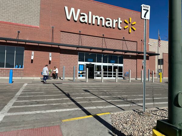 FILE -Shoppers outside a Walmart store, Feb. 7, 2025, in Englewood, Colo. (AP Photo/David Zalubowski), File)