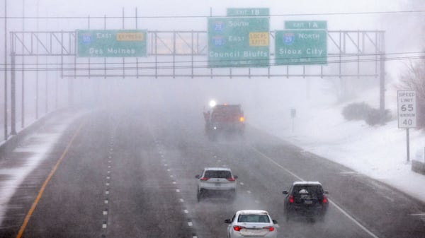 Vehicles follow a snow plow on eastbound I80 during a blizzard in Omaha, Neb. on Wednesday, March 19, 2025. (Chris Machian/Omaha World-Herald via AP)