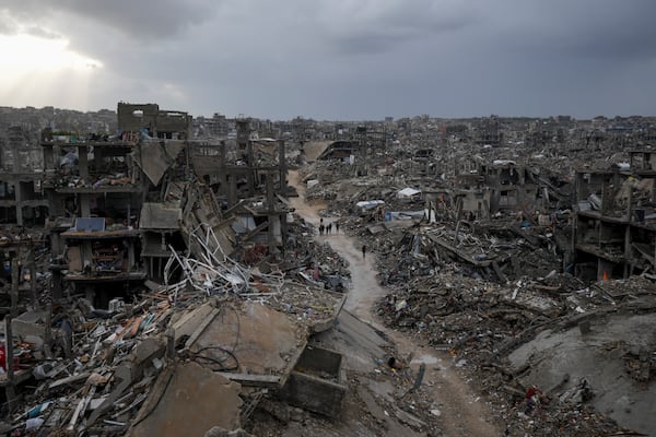 Palestinians walk in the destruction caused by the Israeli air and ground offensive in Jabaliya, Gaza Strip, Thursday, Feb. 6, 2025. (AP Photo/Abdel Kareem Hana)