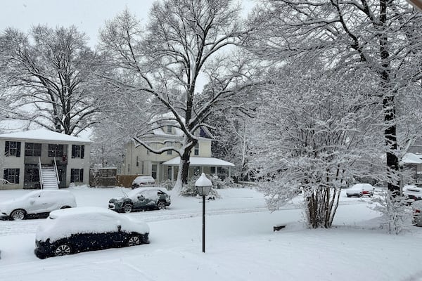 Snow blankets a street in Memphis, Tennessee, Friday, Jan. 10, 2025. (AP Photo/Adrian Sainz)