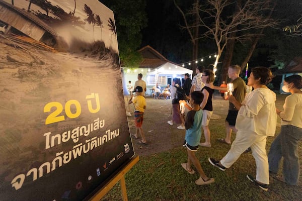 Relatives of victims and survivors of the 2004 Indian Ocean tsunami hold a candle light vigil on the 20th anniversary, at Tsunami Memorial Park at Ban Nam Khem, Takuapa district of Phang Nga province, southern Thailand, Thursday, Dec. 26, 2024. (AP Photo/Wason Wanichakorn)