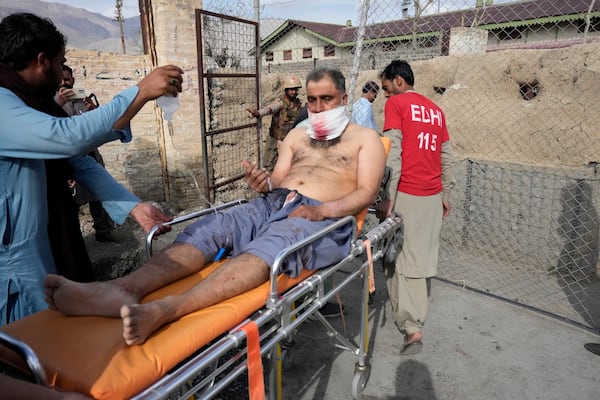 An injured passenger rescued by security forces from a passenger train attacked by insurgents arrive at a railway station in Much near Quetta, Pakistan's southwestern Balochistan province, Wednesday, March 12, 2025. (AP Photo/Anjum Naveed)