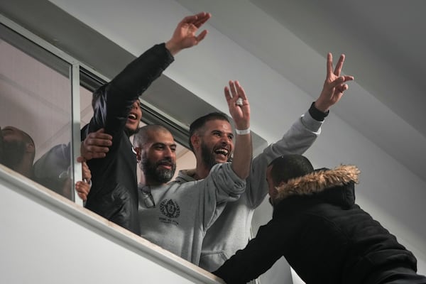 Palestinian prisoners are greeted by a crowd after getting off a bus following their release from an Israeli prison after a ceasefire agreement with Israel, in the West Bank city of Ramallah, Saturday, Jan. 25, 2025.(AP Photo/Mahmoud Illean)