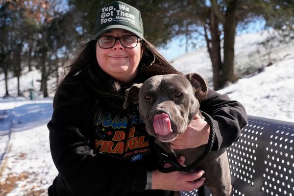 Volunteer Adrian Budnick poses with a dog outside the Metro Animal Care and Control, Thursday, Feb. 20, 2025, in Nashville, Tenn. (AP Photo/George Walker IV)