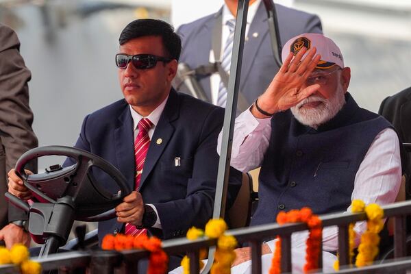 Indian Prime Minister Narendra Modi greets as he arrives for the commissioning ceremony of a submarine, a destroyer and a frigate built at a state-run shipyard in Mumbai, India, Wednesday, Jan. 15, 2025. (AP Photo/Rafiq Maqbool)