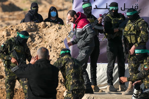 Israeli Yarden Bibas, 34, who has been held hostage by Hamas in Gaza since October 7, 2023, is escorted by Hamas fighters before being handed over to the Red Cross in Khan Younis, southern Gaza Strip, Saturday Feb. 1, 2025. Photo/Abdel Kareem)