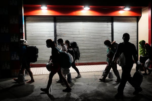 Migrants, mostly from Asian countries, arrived in Panama City on Saturday, March 8, 2025, after spending weeks in a temporary Panamanian immigration camp following their deportation from the U.S. and being released on the condition that they leave the country within 30 days. (AP Photo/Matias Delacroix)