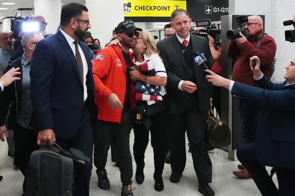 Enrique Tarrio, center, walks with his attorneys after arriving at Miami International Airport, Wednesday, Jan. 22, 2025, in Miami. Tarrio was pardoned by President Donald Trump after he was convicted of seditious conspiracy for his role in the January 6 attack on the U.S. Capitol. (AP Photo/Marta Lavandier)