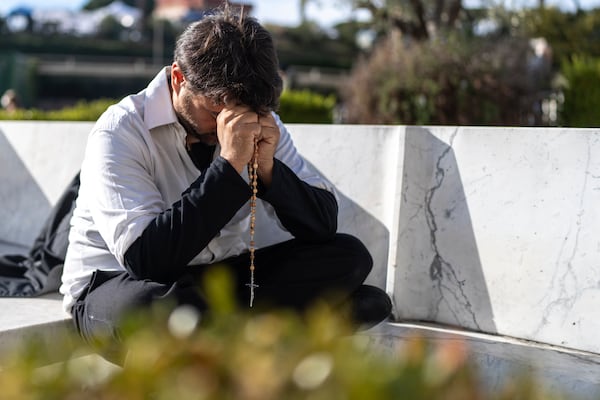 A faithful prays outside the Agostino Gemelli Polyclinic, in Rome, Friday, Feb. 28, 2025 where Pope Francis is hospitalized since Friday, Feb. 14. (AP Photo/Mosa'ab Elshamy)