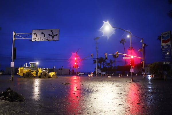 Mud covers Sunset Blvd. in the Palisades Fire zone during a storm Thursday, Feb. 13, 2025, in the Pacific Palisades neighborhood of Los Angeles. (AP Photo/Ethan Swope)