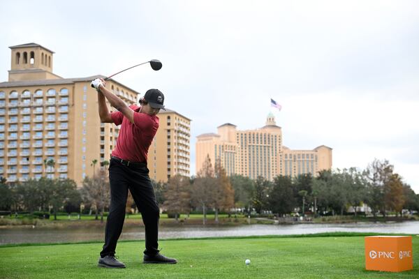 Charlie Woods tees off on the 18th hole during the final round of the PNC Championship golf tournament, Sunday, Dec. 22, 2024, in Orlando, Fla. (AP Photo/Phelan M. Ebenhack)