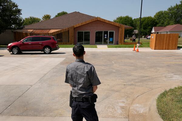 FILE - Security personnel stand outside a recently opened Planned Parenthood clinic, Sept. 10, 2024, in Pittsburg, Kan. (AP Photo/Charlie Riedel)