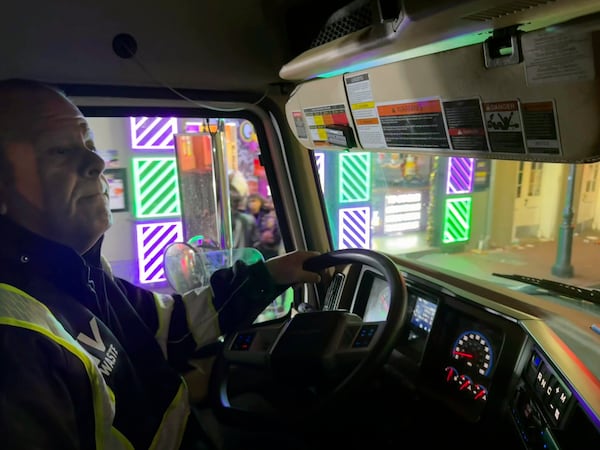 Leander Nunez, 54, navigates a truck down Bourbon Street in New Orleans on Ash Wednesday, March 5, 2025, as part of post-Mardi Gras clean up efforts beginning before dawn. (AP Photo/Jack Brook)