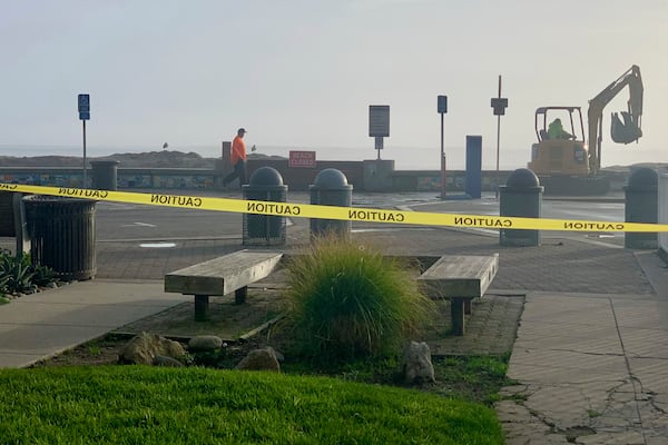 Caution tape closes Capitola Beach due to high surf on Monday, Dec. 23, 2024, in Capitola, Calif. (AP Photo/Pamela Hassell)