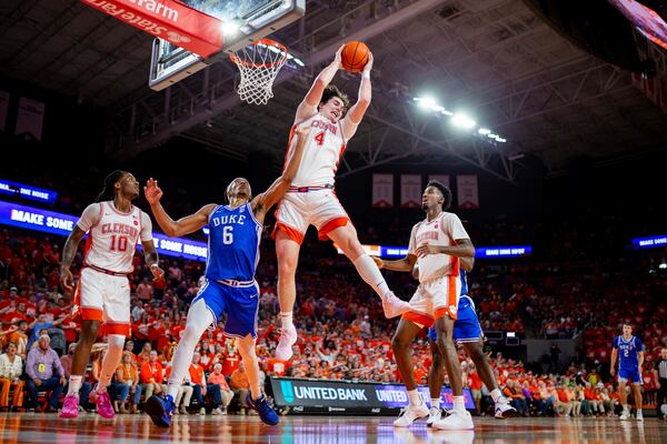 Clemson forward Ian Schieffelin (4) grabs a rebound over Duke forward Maliq Brown (6) during the first half of an NCAA college basketball game Saturday, Feb. 8, 2025, in Clemson, S.C. (AP Photo/Scott Kinser)