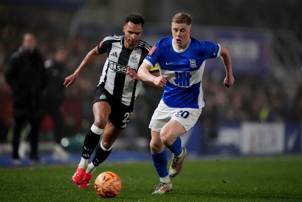 Newcastle United's Jacob Murphy, left, and Birmingham City's Alex Cochrane in action during the English FA Cup fourth round soccer match between Birmingham City and Newcastle United at in Birmingham, England, Saturday Feb. 8, 2025. (Bradley Collyer/PA via AP)