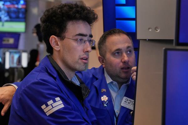 Specialists Alex Weitzman, left, and Gennaro Saporito work on the floor of the New York Stock Exchange, Thursday, May 1, 2025. (AP Photo/Richard Drew)