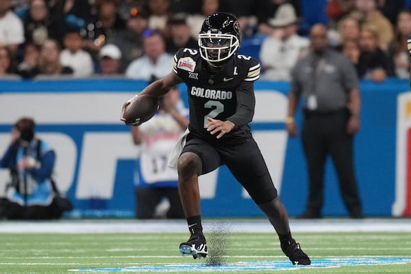 Colorado quarterback Shedeur Sanders (2) scramble for yardage against BYU during the first half of the Alamo Bowl NCAA college football game, Saturday, Dec. 28, 2024, in San Antonio. (AP Photo/Eric Gay)