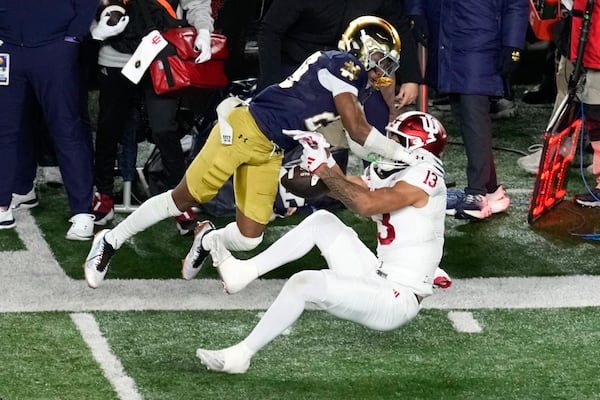 Indiana wide receiver Elijah Sarratt (13) pulls in 28-yard reception as Notre Dame cornerback Christian Gray (29) defends during the first half in the first round of the NCAA College Football Playoff, Friday, Dec. 20, 2024, in South Bend, Ind. (AP Photo/Darron Cummings)