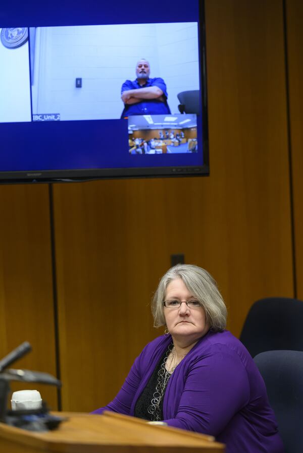 Tanya Zuvers looks away as her former husband John Skelton appears via video from Bellamy Creek Correctional Facility during a hearing by Zuvers to have her sons Andrew, Alexander, and Tanner Skelton be officially declared deceased, at Lenawee County probate court, in Adrian, Mich., March 3, 2025. (David Guralnick/Detroit News via AP)