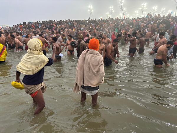 Hindus take holy dips at the confluence of the Ganges, the Yamuna and the mythical Saraswati rivers on Makar Sankranti, an auspicious bathing day of the 45-day-long Maha Kumbh festival in Prayagraj, India, Tuesday, Jan. 14, 2025. (AP Photo/Ashwini Bhatia)