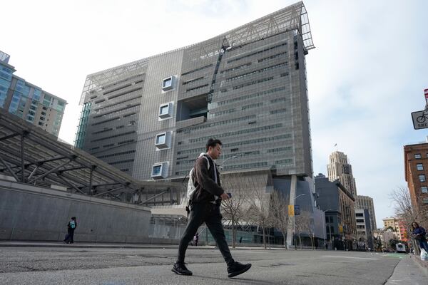 A pedestrian walks by the Speaker Nancy Pelosi Federal Building in San Francisco, Tuesday, March 4, 2025. (AP Photo/Godofredo A. Vásquez)