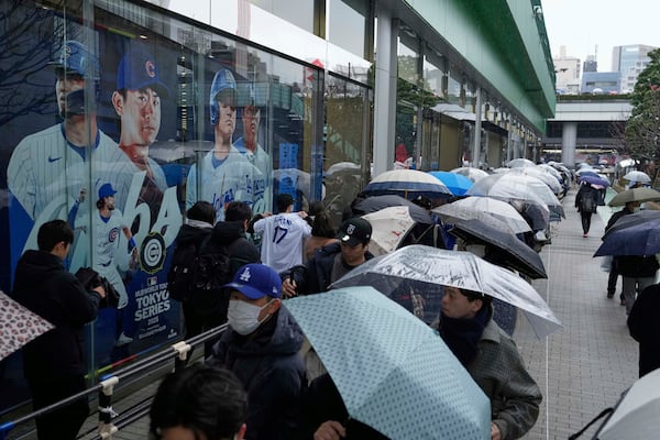 Baseball fans wait in line to get into an MLB souvenir store before the Tokyo Series exhibition games with the Los Angeles Dodgers, the Chicago Cubs, the Yomiuri Giants and the Hanshin Tigers at Tokyo Dome in Tokyo, Sunday, March 16, 2025. (AP Photo/Hiro Komae)