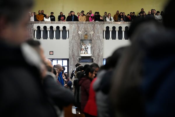 Church members pray during a service at St. Rita of Cascia Parish in Chicago, Sunday, Jan. 19, 2025. (AP Photo/Nam Y. Huh)