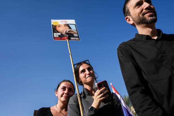 People react as they watch broadcast of the release of Israeli soldier Agam Berger, one of eight hostages set to be released today as part of a ceasefire in the Gaza Strip, in Tel Aviv, Israel, Thursday, Jan. 30, 2025. (AP Photo/Oded Balilty)