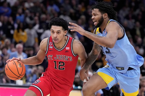 St. John's's RJ Luis Jr. gets past Marquette's David Joplin during the second half of an NCAA college basketball game Saturday, March 8, 2025, in Milwaukee. (AP Photo/Morry Gash)