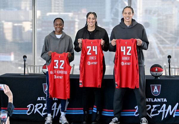 Atlanta Dream's new players, from left, Shatori Walker-Kimbrough, Brionna Jones and Brittney Griner pose for photographers during a WNBA basketball news conference, Tuesday, Feb. 4, 2025, in Atlanta. (Hyosub Shin/Atlanta Journal-Constitution via AP)