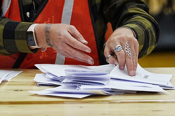 Votes are counted at DCBL Halton Stadium, in Widnes, Cheshire, England, for the Runcorn and Helsby by-election that was triggered by the resignation of former Labour MP Mike Amesbury, Thursday, May 1, 2025. (Peter Byrne/PA via AP)