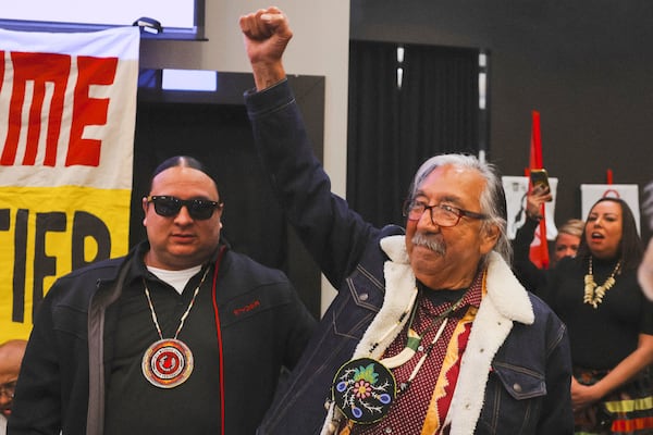 In this image provided by the NDN Collective, Leonard Peltier, right, a Native American activist released from a Florida prison where he had been serving a life sentence in the 1975 killings of two FBI agents, raises his fist during a welcome event, Wednesday, Feb. 19, 2025, at the Sky Dancer Casino Resort near Belcourt, N.D., on the Turtle Mountain Reservation. (Angel White Eyes'NDN Collective via AP)